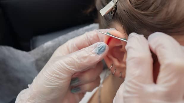 person getting an industrial piercing.