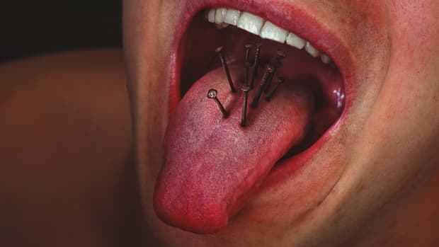 person with pins and needles in their tongue.