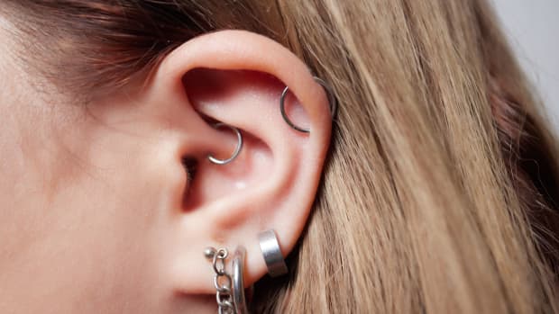 a person with multiple ear piercings.
