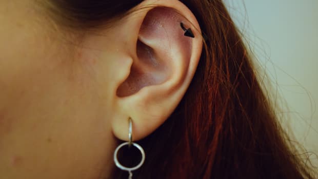 a person with a cartilage piercing.