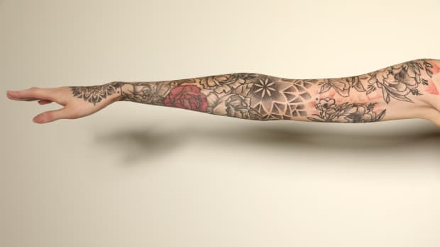 person with an arm full of tattoos.