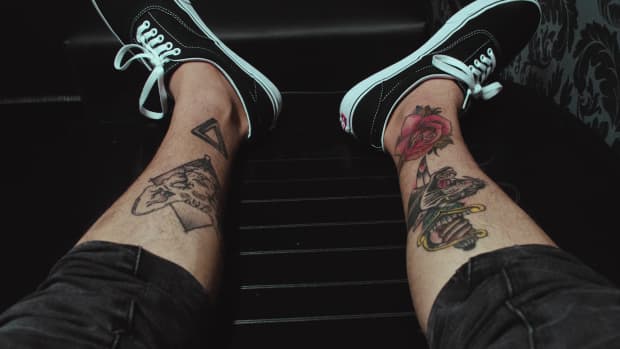 person with leg tattoos.