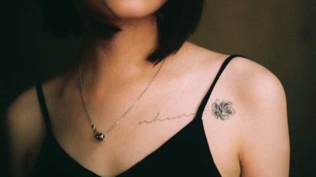 woman with a rose tattoo on her chest.